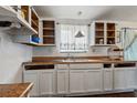 Kitchen featuring rustic open cabinets, durable counter tops, and an ornate hanging lamp at 2486 Daytona Park Rd, Deland, FL 32724
