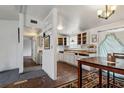 Bright kitchen with open cabinets and rustic flooring flowing to dining area at 2486 Daytona Park Rd, Deland, FL 32724