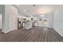 Open kitchen featuring stainless appliances, a center island, granite countertops, and access to the backyard at 15673 Sw 37 Cir, Ocala, FL 34482