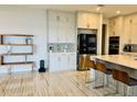 Bright kitchen featuring custom cabinets, stainless steel appliances, a large island, and modern marble floors at 16832 Bolsena Dr, Bella Collina, FL 34756