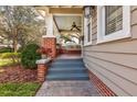 Inviting front porch with brick accents, fan, and space for seating at 600 Dartmouth St, Orlando, FL 32804