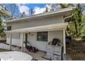 View of home exterior showing front porch, lawnmower, driveway, and white car parked at 1630 Lakeview Ct, Eustis, FL 32726