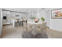 Bright dining area with modern table, chairs, and an open layout connected to a kitchen with white cabinetry at 1132 Avenue K # A, Haines City, FL 33844