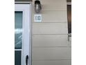 Close up of a condominium entrance showing the door, unit number, and surrounding wall at 335 N Causeway # E3, New Smyrna Beach, FL 32169