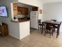 Bright kitchen and dining area with tiled floor, wood cabinets, and modern appliances at 335 N Causeway # E3, New Smyrna Beach, FL 32169