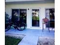 Patio featuring a sliding glass door, a chair, and two bicycles in front of the unit at 335 N Causeway # E3, New Smyrna Beach, FL 32169