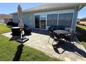 Outdoor patio with beautiful pavers, furniture, and an umbrella to provide shade on sunny days at 3345 Tesoro Cir, New Smyrna Beach, FL 32168