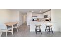Open-concept living area showcasing a modern kitchen with an island and dining space at 6677 Sw 81St Loop, Ocala, FL 34476