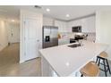 Bright kitchen featuring white cabinets, stainless steel appliances, and a peninsula with bar seating at 6677 Sw 81St Loop, Ocala, FL 34476
