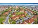 Aerial view of a community with well-maintained townhomes, terracotta roofs, and lush green landscaping at 2634 Andros Ln, Kissimmee, FL 34747