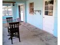 Enclosed patio with a table and chairs, offering a versatile space for dining and relaxation at 3695 Dale Ct, Mount Dora, FL 32757