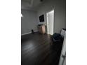 Bedroom showcasing dark wood floors, complemented by neutral walls, a wooden dresser and a TV at 2822 Seymore St, Lakeland, FL 33813
