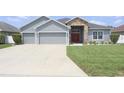 Charming one-story home featuring gray siding and a spacious driveway at 2822 Seymore St, Lakeland, FL 33813