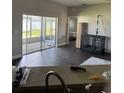 Cozy living room with sliding glass doors and views to screened patio at 2822 Seymore St, Lakeland, FL 33813