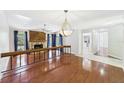 Bright living room showcasing wood floors, a stone fireplace, and contemporary lighting at 1776 E Cheryl Dr, Winter Park, FL 32792