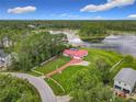 Aerial view showing the house and its surroundings near a body of water and neighboring houses at 318 Mitnik Dr, Deltona, FL 32738