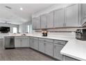 Well-lit kitchen featuring stainless steel appliances, quartz countertops, gray cabinets, and wood-look floors, great for cooking at 11331 Sw 54Th Cir, Ocala, FL 34476