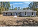 Inviting single-story home featuring a cozy entrance and manicured garden beds at 5593 Sw 199Th Ct, Dunnellon, FL 34431