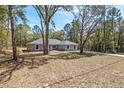 A picturesque home surrounded by mature trees and natural landscaping at 5593 Sw 199Th Ct, Dunnellon, FL 34431