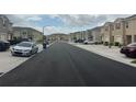 A street lined with newly built townhouses, showcasing the community's layout and design at 1026 Lido Dr, Howey In The Hills, FL 34737