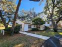 Quaint two-story house surrounded by mature trees, with a charming, freshly painted exterior and well-manicured lawn at 7990 Midway Drive Ter # M103, Ocala, FL 34472