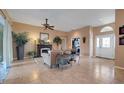 Spacious living room with tile flooring, ceiling fan and fireplace at 4435 Fairway Oaks Dr, Mulberry, FL 33860
