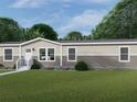 Beautiful home exterior with a well-manicured lawn, a stone foundation, and colorful flowerbeds at 9124 Sw 158Th Ln, Dunnellon, FL 34432