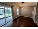 Open dining room with wood floors, modern lighting, and sliding glass doors to the screened patio at 12113 Calaboose Ct, Orlando, FL 32828
