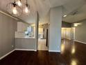 Open floor plan showcasing the modern kitchen with white cabinets and stainless steel appliances adjacent to the dining and living areas at 12113 Calaboose Ct, Orlando, FL 32828
