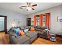 Spacious living room with hardwood floors, a comfortable sectional sofa, and abundant natural light from the windows at 501 Washington Ave, Eustis, FL 32726
