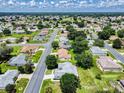 A beautiful aerial view showcases a neighborhood with well-maintained homes, mature trees, and a lush green landscape at 13729 Se 89Th Ave, Summerfield, FL 34491