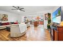 Open-concept living room and kitchen area, filled with natural light at 3747 Woodbury Hill Loop, Lakeland, FL 33810