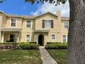 Attractive stucco home with neat landscaping, sidewalk, and a mature tree in the front yard at 387 Winter Nellis Cir, Winter Garden, FL 34787