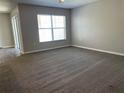 Spacious living room with neutral carpet, natural light, and a sliding glass door at 387 Winter Nellis Cir, Winter Garden, FL 34787
