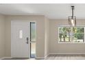 Bright entryway with a large window offering views of tropical landscaping at 15690 Sw 46Th Cir, Ocala, FL 34473