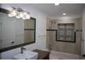 Beautiful bathroom featuring a tiled shower, tub, decorative inset and large mirror at 124 Auburn Rd, Auburndale, FL 33823