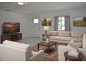 Bright living room featuring modern furnishings, neutral color palette, and ample natural light at 124 Auburn Rd, Auburndale, FL 33823