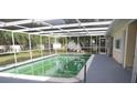 Inviting in-ground pool surrounded by a screened enclosure, perfect for relaxation at 124 Auburn Rd, Auburndale, FL 33823