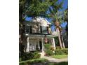 Charming two-story home featuring a cozy front porch with tasteful landscaping at 9826 Poplar Pl, Orlando, FL 32827