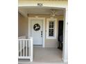 Inviting front door with decorative wreath and covered porch area with fan at 9826 Poplar Pl, Orlando, FL 32827