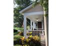 Cozy covered front porch with fan and ample seating for relaxing outdoors at 9826 Poplar Pl, Orlando, FL 32827