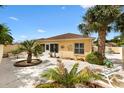 Spacious backyard with a concrete patio, lush tropical landscaping, and plenty of space for outdoor entertaining at 1139 Santa Cruz Dr, The Villages, FL 32162