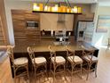 Modern kitchen with large island, stainless steel appliances, and stylish seating at 3060 Rockefeller Way # 156, Kissimmee, FL 34747