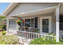 Inviting front porch with wicker seating and plants creates a cozy outdoor space at 11540 Sw 84Th Avenue Rd, Ocala, FL 34481