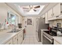 Well-lit kitchen features stainless steel appliances, tiled backsplash, and ample counter space at 11540 Sw 84Th Avenue Rd, Ocala, FL 34481