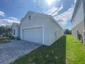 Charming single-Gathering home featuring a two-car garage and lush green lawn at 4910 Lyric Dr, Mascotte, FL 34753