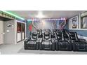 Modern home theater with leather recliner seating and unique decorative wall elements at 2710 Manesty Ln, Kissimmee, FL 34747