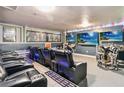 Spacious home theater featuring comfortable seating, colorful LED lighting, and multiple screens at 2710 Manesty Ln, Kissimmee, FL 34747