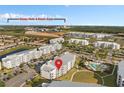 Aerial view showcases the condo near Disney Parks and Resorts, plus community pool and green spaces at 3120 Paradox Cir # 307, Kissimmee, FL 34746