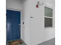 Blue front door with welcome mat, doorbell, and window on a white exterior wall at 3120 Paradox Cir # 307, Kissimmee, FL 34746